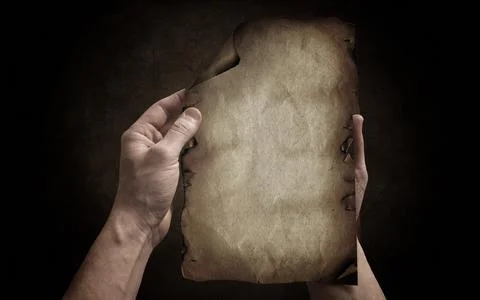 Hands bring the old paper on the dark background Stock Photos