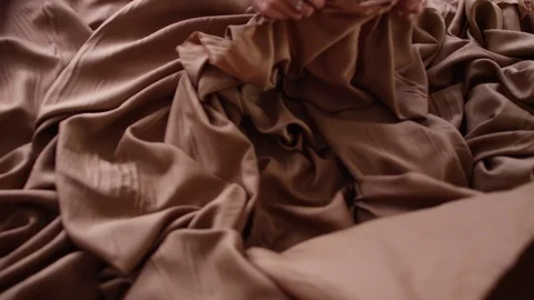 Hands on Brown Fabrics Stock Footage 104900936