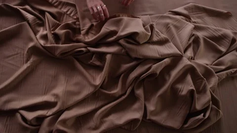 Hands On Brown Fabrics Stock Footage 104904941