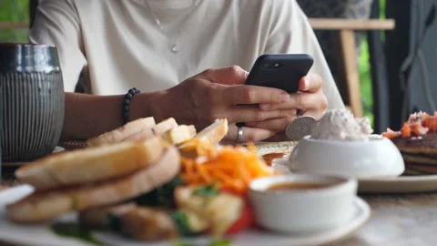 Hands browsing on the phone on the background in the focus. Blurred foreground Stock Footage 149726058
