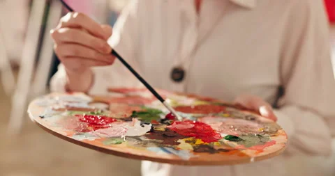 Hands, brush and blend paint with palette to create different color, DIY project Stock Footage 346293969