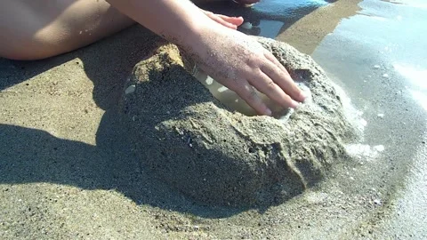 Hands build sand forms Stock Footage 268841030