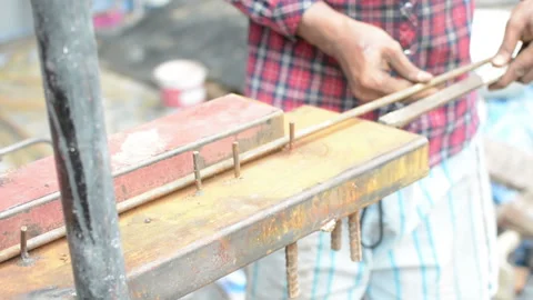 The hands of the builder are bending the iron at site construction Stock Footage 137818239
