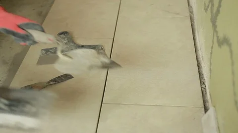 Hands of the Builder laid out the tools for laying tile Stock Footage 94422976