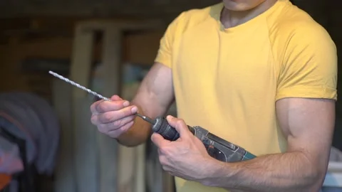 In the hands of the builder a perforator, hammer drill Stock Footage 159239324