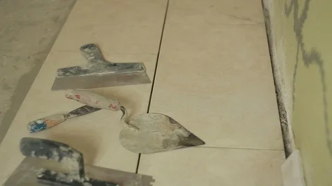 Hands of the Builder take the tiles with a spatula and trowel Stock Footage 94829376