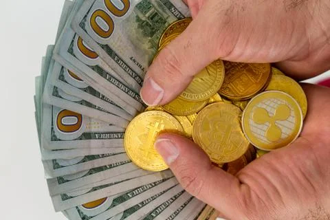 Hands with bundle of banknotes with coins Foto stock