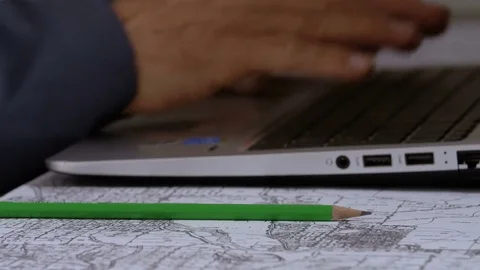 Hands of business man typing on laptop and writing with pencil Stock Footage