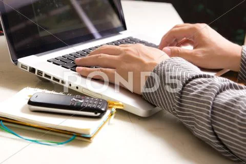 Hands of business man typing on notebook Stock Photos