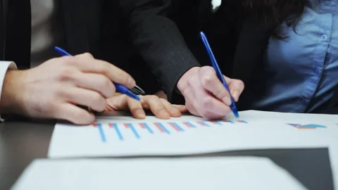 Hands of business team making notes on growth graph at meeting Stock Footage 202110042