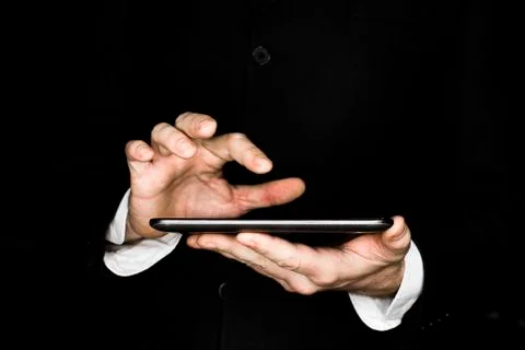 Hands of a businessman work with a tablet computer. Stock Photos