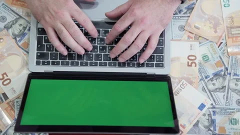 Hands of a businessman working at a computer with a green screen, surrounde.. Stock Footage 313188030