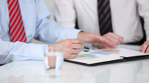 Hands of businessmen discussing a chart Stock-Footage 26958545