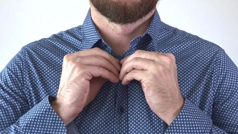 Hands buttoning a blue shirt not completely. 動画素材 249662246