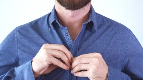 Hands buttoning a blue shirt not completely. Stock Footage 249662285