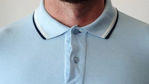 Hands buttoning a polo shirt all the way up. Stock Footage 205076065
