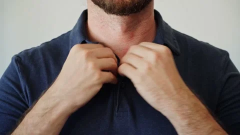 Hands buttoning a polo shirt not completely. Stock Footage 205076062