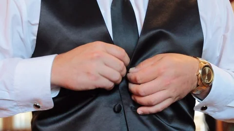 Hands buttoning silky black vest formal Stock Footage 91158098