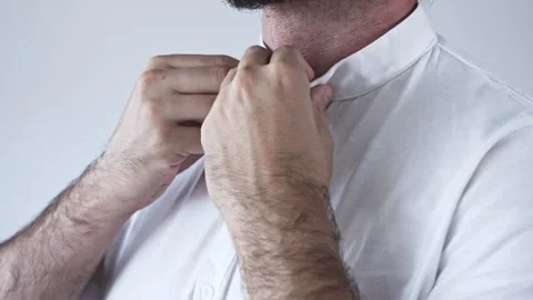 Hands buttoning a white shirt all the way up. Stock Footage 249662253