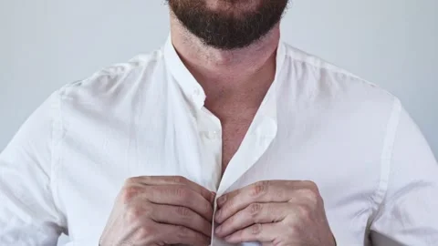Hands buttoning a white shirt not completely. Stock Footage 249662236