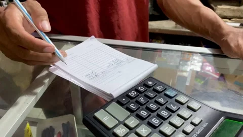 Hands Calculating Total Price Using Calculator Stock Footage 324966190