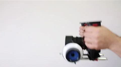 Hands cameraman with a camera on a white background Stock Footage 55676343