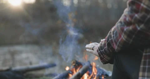 Hands by the campfire for warmth Stock Footage 347838226