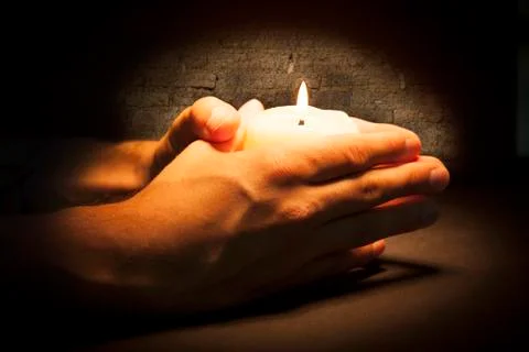 Hands with candle Stock Photos