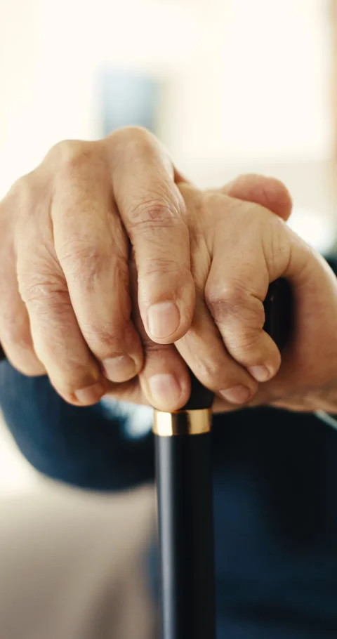 Hands, cane and elderly man in home for thinking, healing and osteoporosis in Stock Footage 342230498