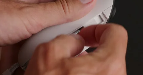 Hands can't extract battery from wireless joystick for VR headset. Stock Footage 258063483