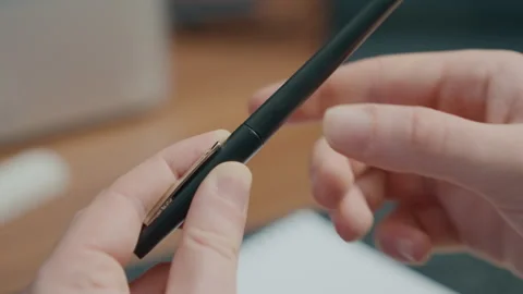 Hands Capping a Black Ballpoint Pen in Slow Motion Stock Footage 348383956