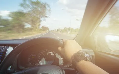 Hands of car driver on steering wheel, fast limit 100 Km/h driving car at  ho Stock Photos