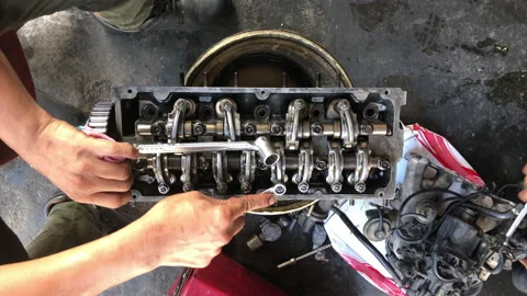 Hands on Car Engine Block petrol gasoline cylinder cam shaft spring rocker arm v Stock Footage 133491528