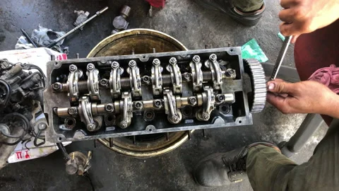Hands on Car Engine Block petrol gasoline cylinder cam shaft spring rocker arm v Stock Footage 133491538