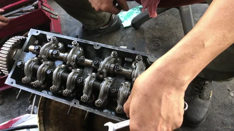 Hands on Car Engine Block petrol gasoline cylinder cam shaft spring rocker arm v Stock Footage 133492689