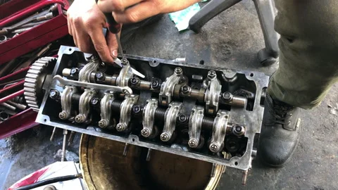 Hands on Car Engine Block petrol gasoline cylinder cam shaft spring rocker arm v Stock Footage 133493818