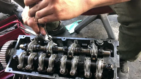 Hands on Car Engine Block petrol gasoline cylinder cam shaft spring rocker arm v Stock Footage 133494327