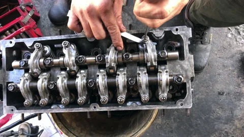 Hands on Car Engine Block petrol gasoline cylinder cam shaft spring rocker arm v Stock Footage 133517486