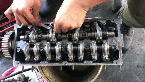 Hands on Car Engine Block petrol gasoline cylinder cam shaft spring rocker arm v Stock Footage 133517903