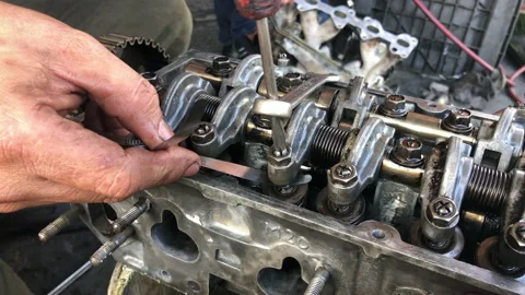 Hands on Car Engine Block petrol gasoline cylinder cam shaft spring rocker arm v Stock Footage 133520273