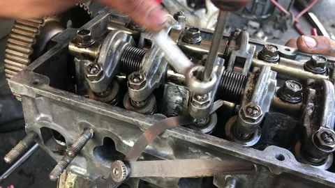 Hands on Car Engine Block petrol gasoline cylinder cam shaft spring rocker arm v Stock Footage 133521204