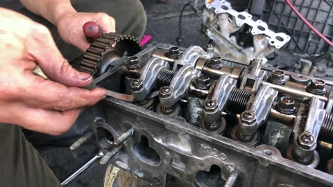 Hands on Car Engine Block petrol gasoline cylinder cam shaft spring rocker arm v Stock Footage 133544248