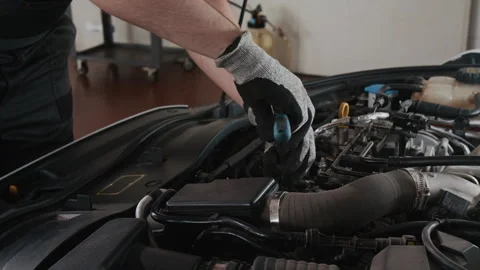 Hands of Car Mechanic Changing Spark Plugs and Replacing Gaskets Stock Footage 329406568