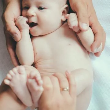 The hands that care. Newborn baby in parents hands. Newborn baby given body Stock Photos