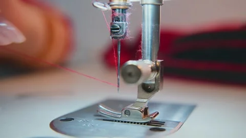 Hands carefully maneuvering material through sewing machine Stock Footage 333750087