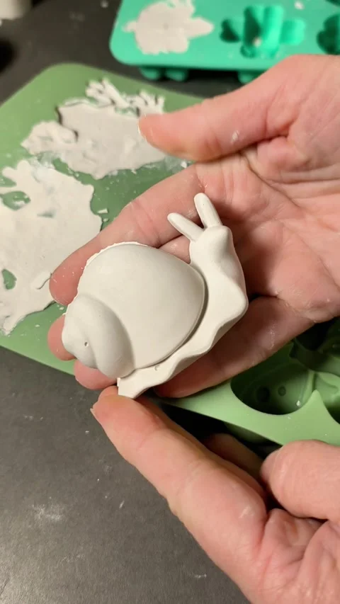 Hands carefully removing plaster figure from mold, Stock Footage 346040946