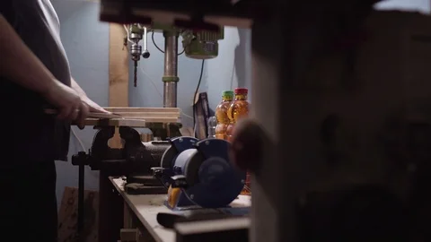 Hands of a carpenter cover up wood of black stain, woodcraft Vidéo 101213655