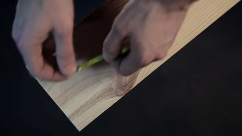 Hands of carpenter measuring a plank with measuring tape Stock Footage 72197067