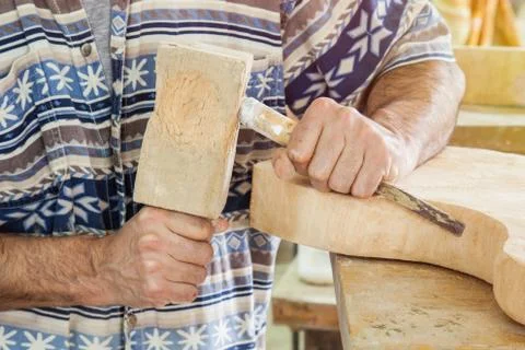 Hands of carpenter processing wood with a chisel Stock Photos