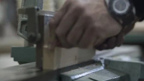 Hands of carpenter sanding sides of board on white belt sander machine, close up Stock Footage 88160073